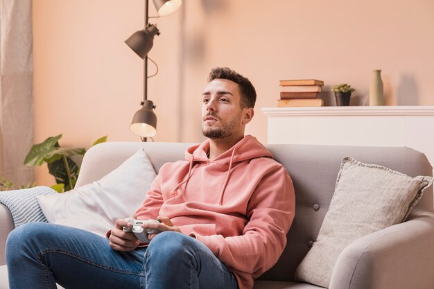 High angle male on couch playing