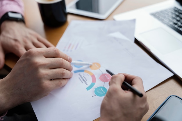 Free photo high angle of male coworkers analyzing graph at work