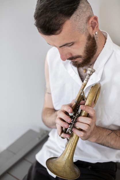 High angle of male musician playing cornet