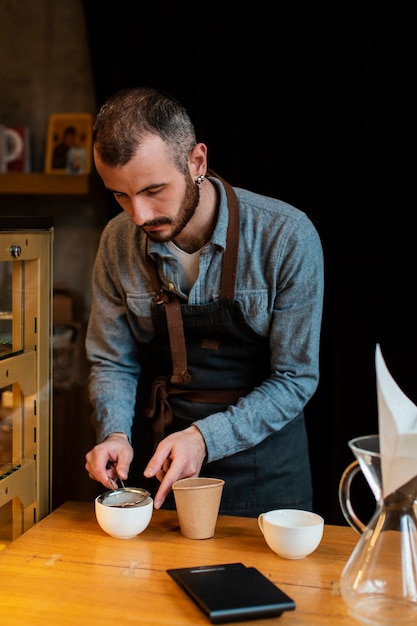 Free photo high angle male preparing coffee