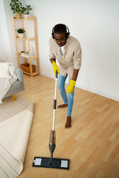 High angle man cleaning floor with mop