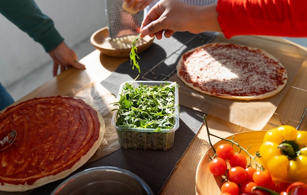 Free photo high angle man cooking delicious pizza