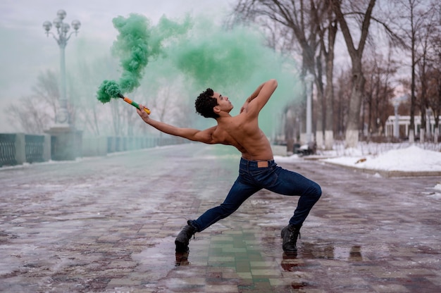 High angle man dancing ballet with color powder