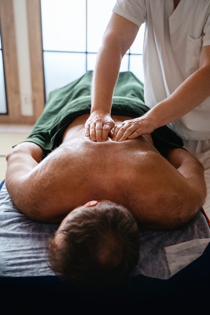 Free photo high angle man getting massage