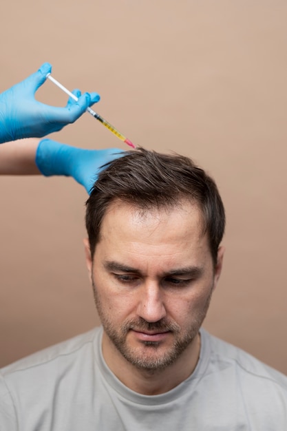 High angle man getting prp injection for alopecia