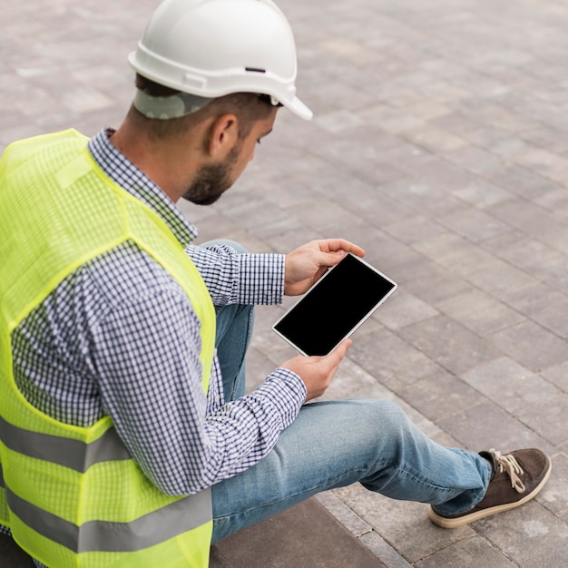 Free Photo high angle man holding tablet