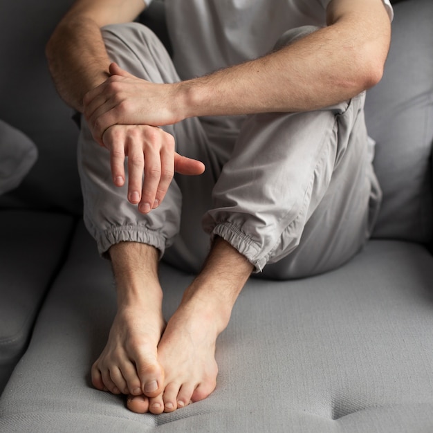 Free photo high angle of man posing while sitting down on the couch