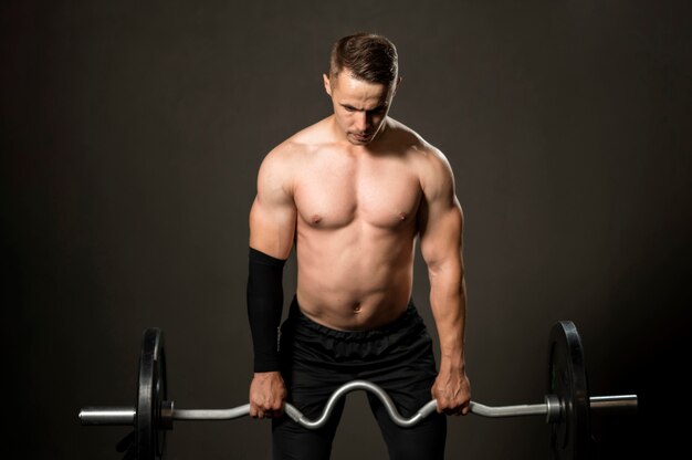 High angle man powerlifting at gym