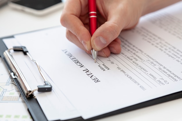 Free Photo high angle man signing a contract for a new house