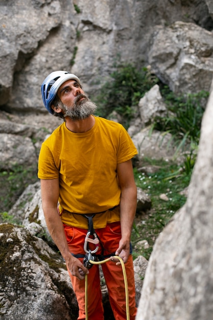 Free photo high angle man with climbing  equipment