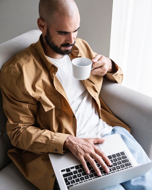 High angle man working on laptop