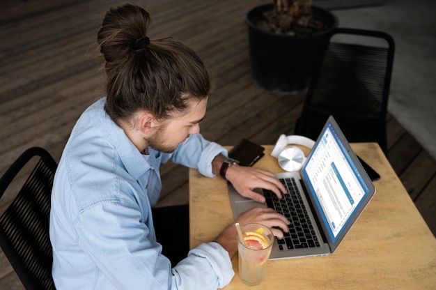 High angle man working on laptop