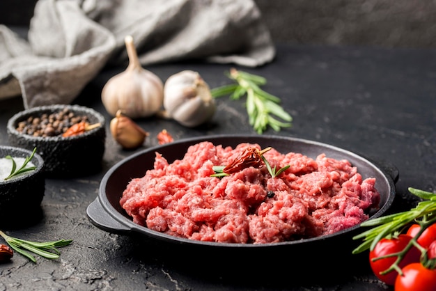 High angle of meat on plate with herbs and garlic