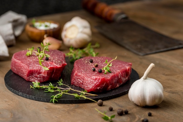 Free photo high angle of meat with herbs and garlic