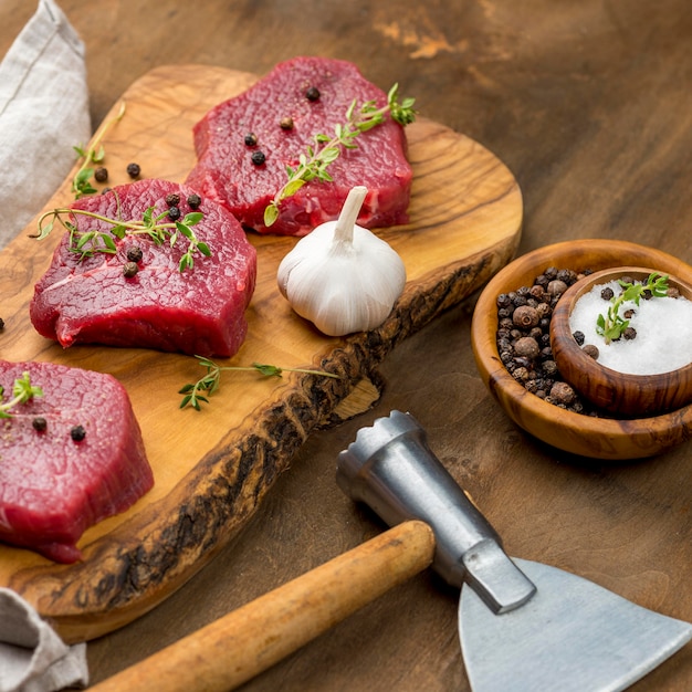 Free Photo high angle of meat with herbs and garlic