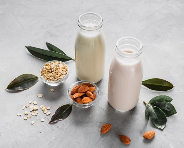 High angle milk bottles with almonds and oats