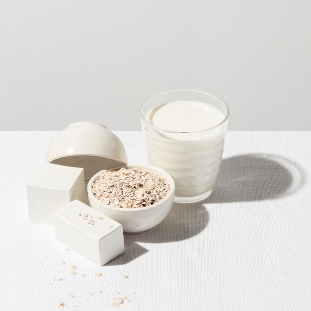 High angle of milk glass with bowl of oatmeal