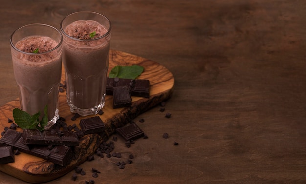 High angle of milkshake glasses with copy space and chocolate