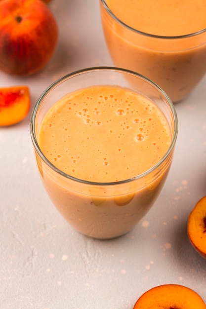 Free photo high angle of milkshake glasses with peaches