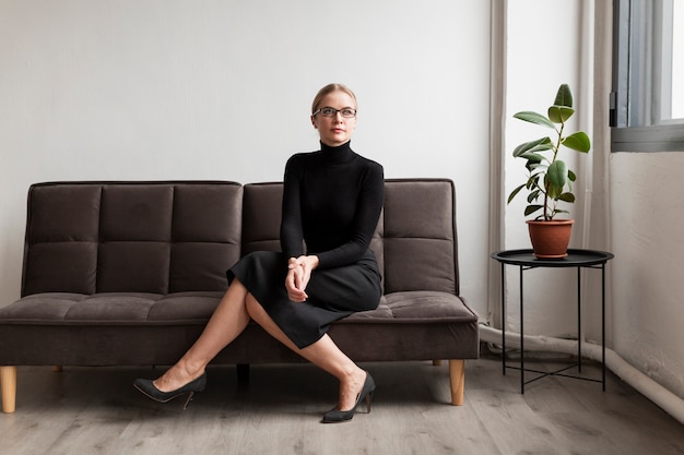 High angle modern woman sitting on couch