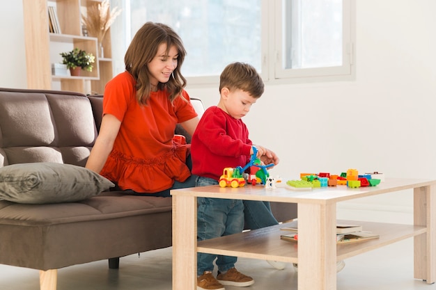 High angle mom watching son while playing