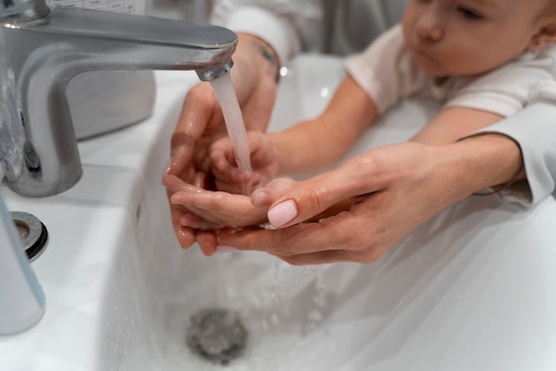 Free photo high angle mother washing baby