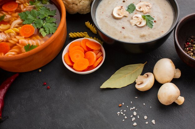 High angle musroom bisque and vegetable soup with fusilli