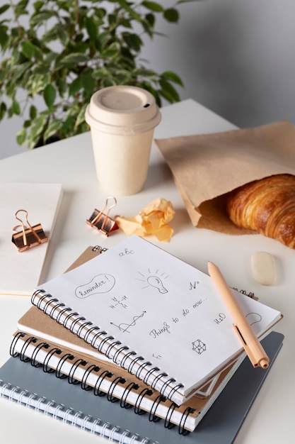 High angle notebooks and croissant