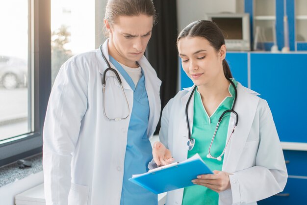 High angle nurses looking at clipboard