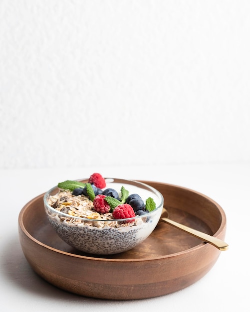 Free Photo high angle of oatmeal bowl with raspberries and copy space