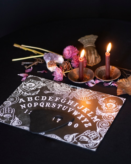 High angle old ouija board and candles