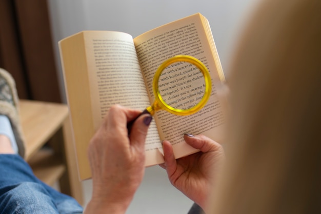 Free Photo high angle old woman reading at home