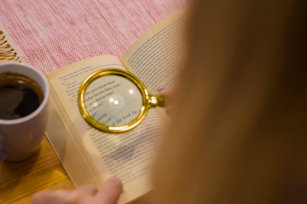 Free Photo high angle old woman reading at home