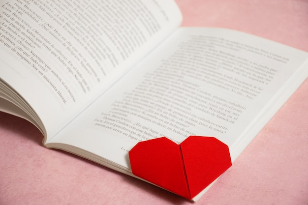 High angle open book and heart bookmark