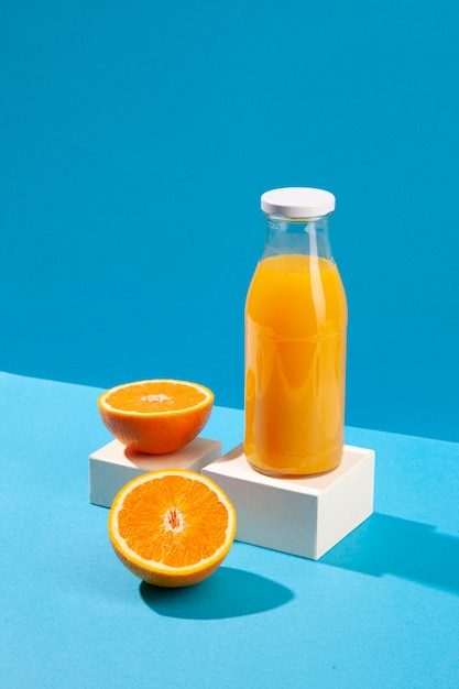 Free photo high angle orange juice bottle