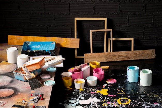 Free photo high angle of painting studio with cans and frames