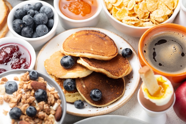 Free photo high angle of pancakes with blueberries and cereal for breakfast