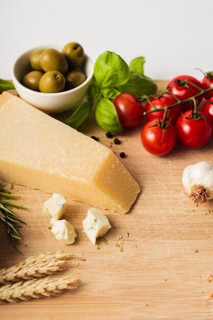 High angle parmesan tomatoes and garlic on cutting board