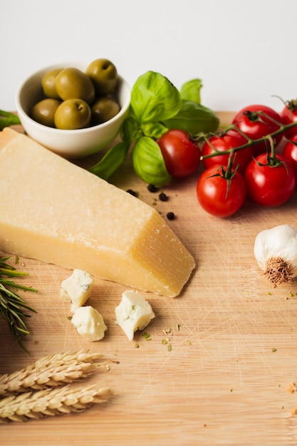 High angle parmesan tomatoes and garlic on cutting board