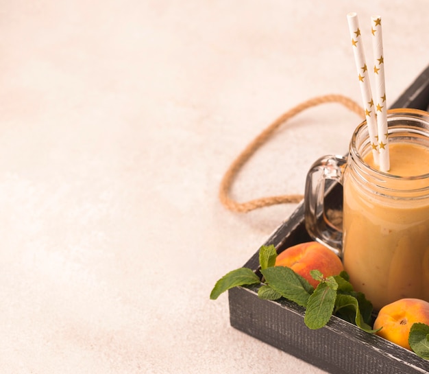 Free photo high angle of peach milkshake with straws and copy space