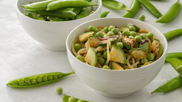 Free photo high angle peas with spaghetti and vegetables in bowl