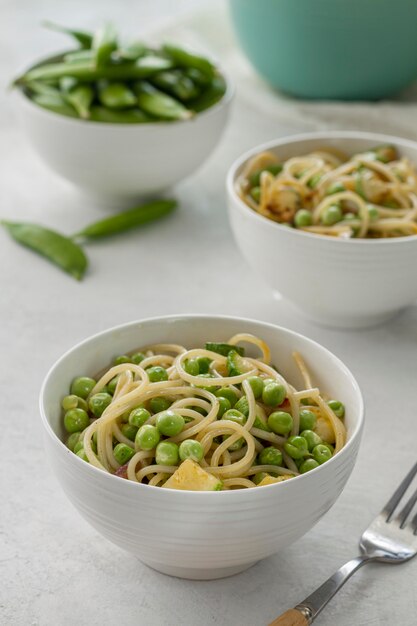 High angle peas with spaghetti