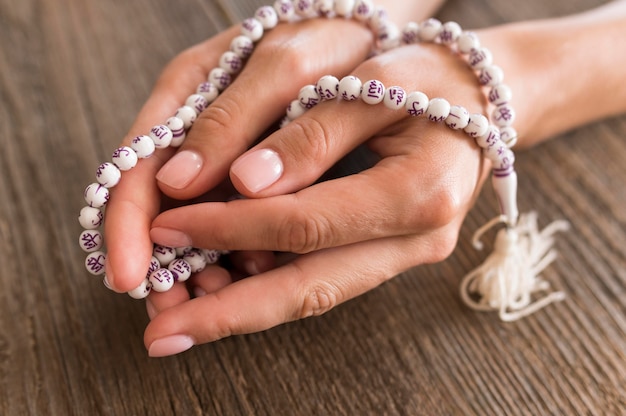 High angle of person praying with rosary in hands