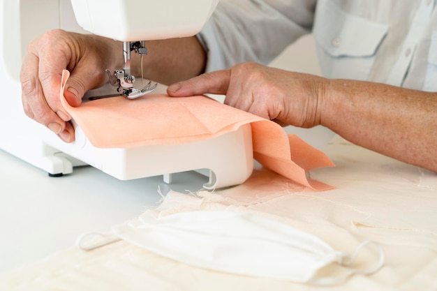 Free Photo high angle of person sewing textiles using machine