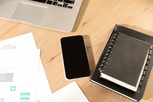 High angle phone and agenda on table