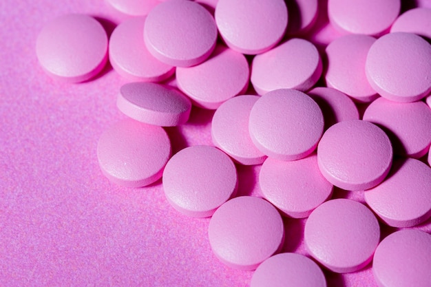 High angle pills on purple background