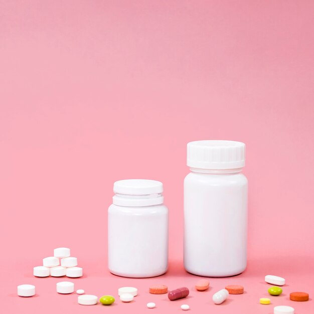 High angle of pills with containers and copy space