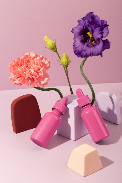 Free Photo high angle pink cosmetic containers