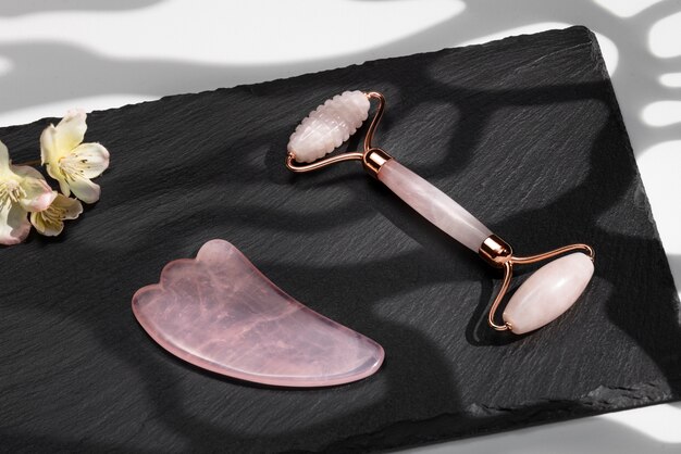 High angle pink gua sha items and flowers