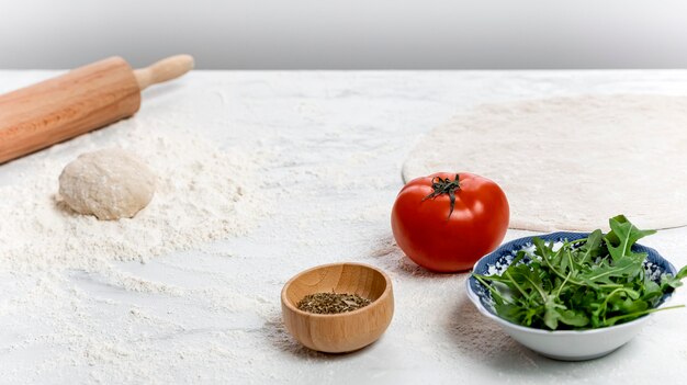 High angle pizza dough and ingredients